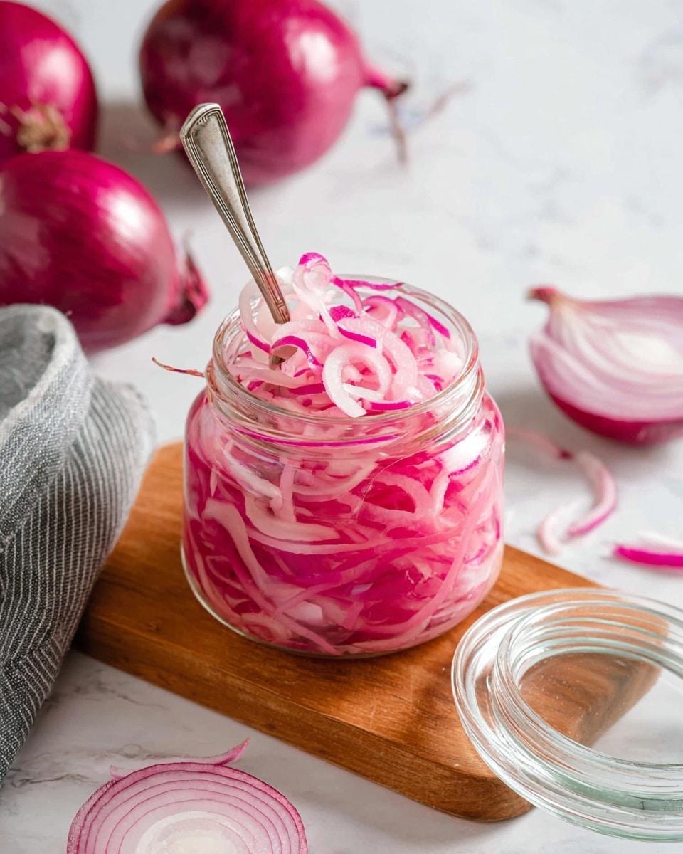 The image shows two jars filled with bright pink pickled onions, placed on a small beige textured tray resting on a white marbled surface. The front jar is open with thin, translucent onion rings that have a mix of light pink and deeper magenta layers, showing some rings floating in clear pinkish liquid. A gold fork held by a woman's hand is lifting some onion rings out of the front jar, highlighting the curls and wet texture of the onions. The second jar in the background is closed and also filled with the same vivid pink onions. The soft light creates a gentle shine on the glass and onions, enhancing their fresh and tangy look. Photo taken with an iphone --ar 4:5 --v 7