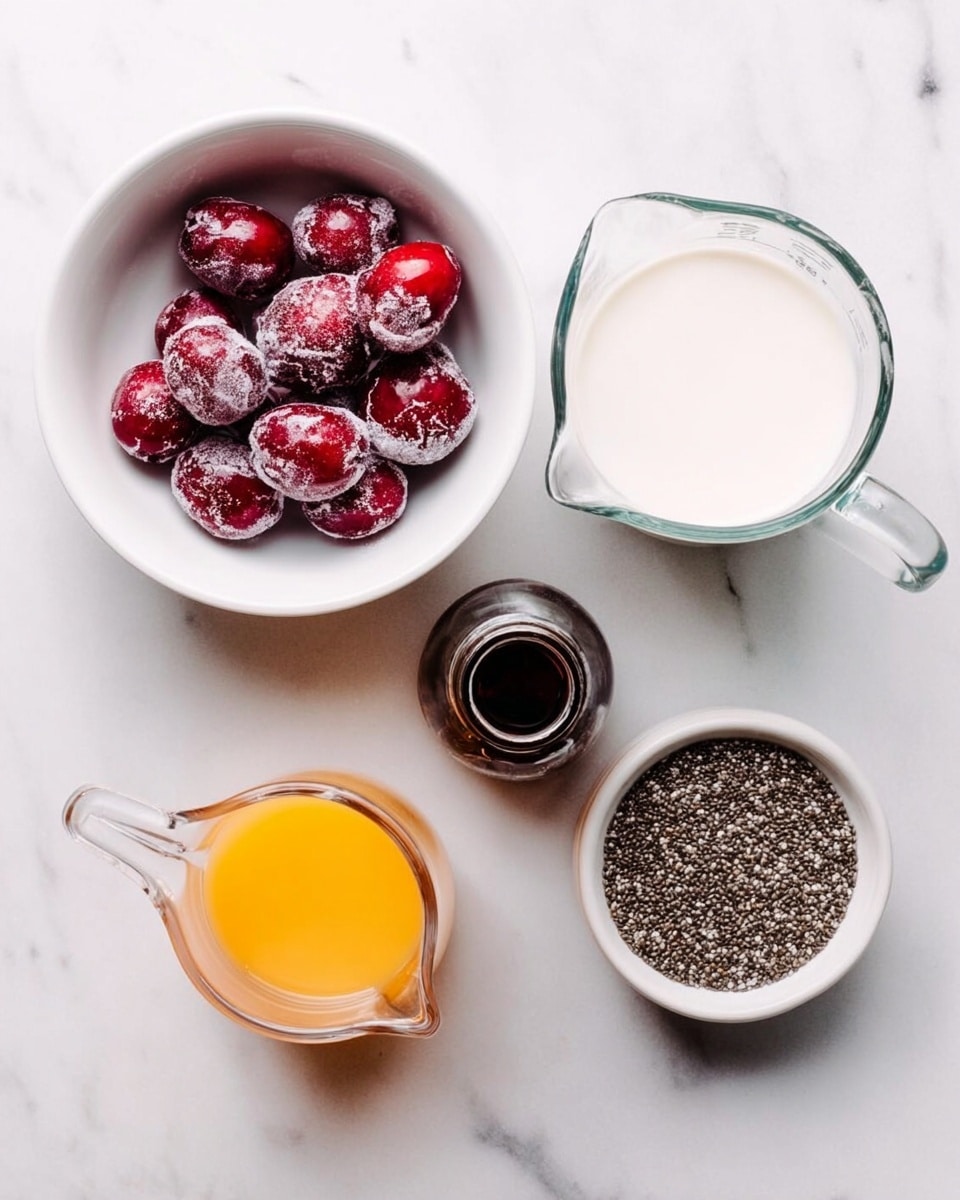 A small transparent glass jar filled with deep purple chia pudding as the first layer, showing a thick texture with visible chia seeds. On top, the pudding is garnished with three layers: golden brown granola on the left, dark brown chocolate chips in the middle, and bright red chopped cherries on the right. The jar sits on a white marbled surface with scattered granola crumbs, and in the background, a white bowl holds whole dark red cherries. Photo taken with an iphone --ar 4:5 --v 7