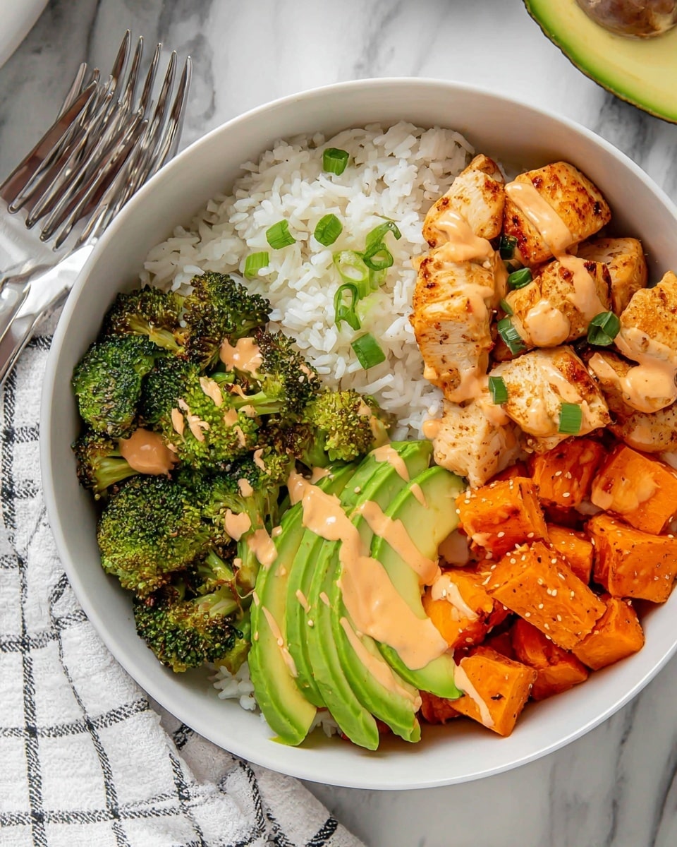 A white bowl filled with four main layers: at the bottom, a fluffy bed of white rice sprinkled with small green onion pieces; on one side, bright green roasted broccoli crowns lightly drizzled with a creamy orange sauce; beside the broccoli, ripe avocado slices arranged in a fan shape showing creamy pale green inside; next to the avocado, golden-brown pieces of cooked chicken with specks of black pepper, also drizzled with the same orange sauce, sitting on a bed of cubed, roasted sweet potatoes in warm orange tones, all placed on a white marbled surface with a folded white and black checkered cloth near the bowl, and silver forks resting on it. Photo taken with an iphone --ar 4:5 --v 7