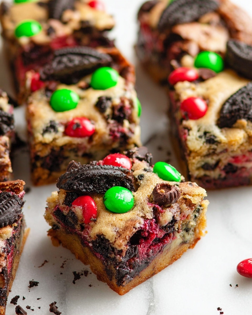 Nine square cookie bars are neatly arranged on a silver cooling rack over a grey cloth, placed on a white marbled surface. Each bar is light brown with a soft texture and is topped with broken dark brown Oreo cookie pieces, bright red and green candy-coated chocolates, and small dark brown chocolate chips scattered evenly. Around the rack, whole dark brown Oreo cookies and extra chocolate chips lie casually on the white marbled surface. The mix of colors and textures make the bars look rich and festive. Photo taken with an iphone --ar 4:5 --v 7