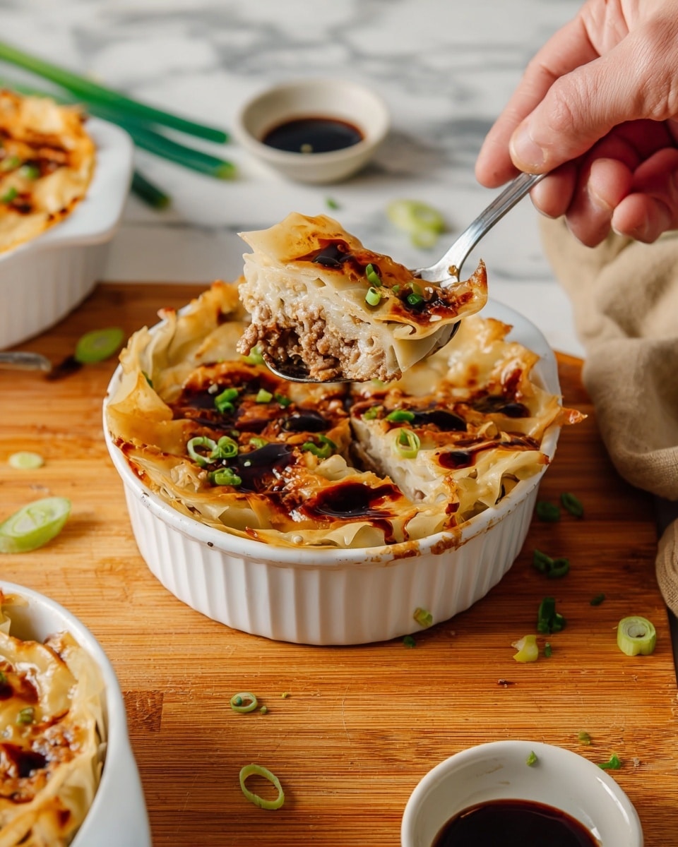 The image shows a white ceramic dish filled with a layered baked dish topped with a thin, golden-brown crispy layer that looks like baked dumpling wrappers or pasta sheets, drizzled with dark soy-based sauce and sprinkled with chopped green onions. Inside the dish, there are visible layers of minced meat and creamy filling beneath the crispy top layer. A woman's hand is holding the dish steady while a metal spoon lifts a bite, showing the textured layers of the filling and the slightly browned wrapper on top. The dishes sit on a wooden surface with small white bowls holding dark dipping sauces and scattered green onion slices around, all set against a white marbled background. Photo taken with an iphone --ar 4:5 --v 7