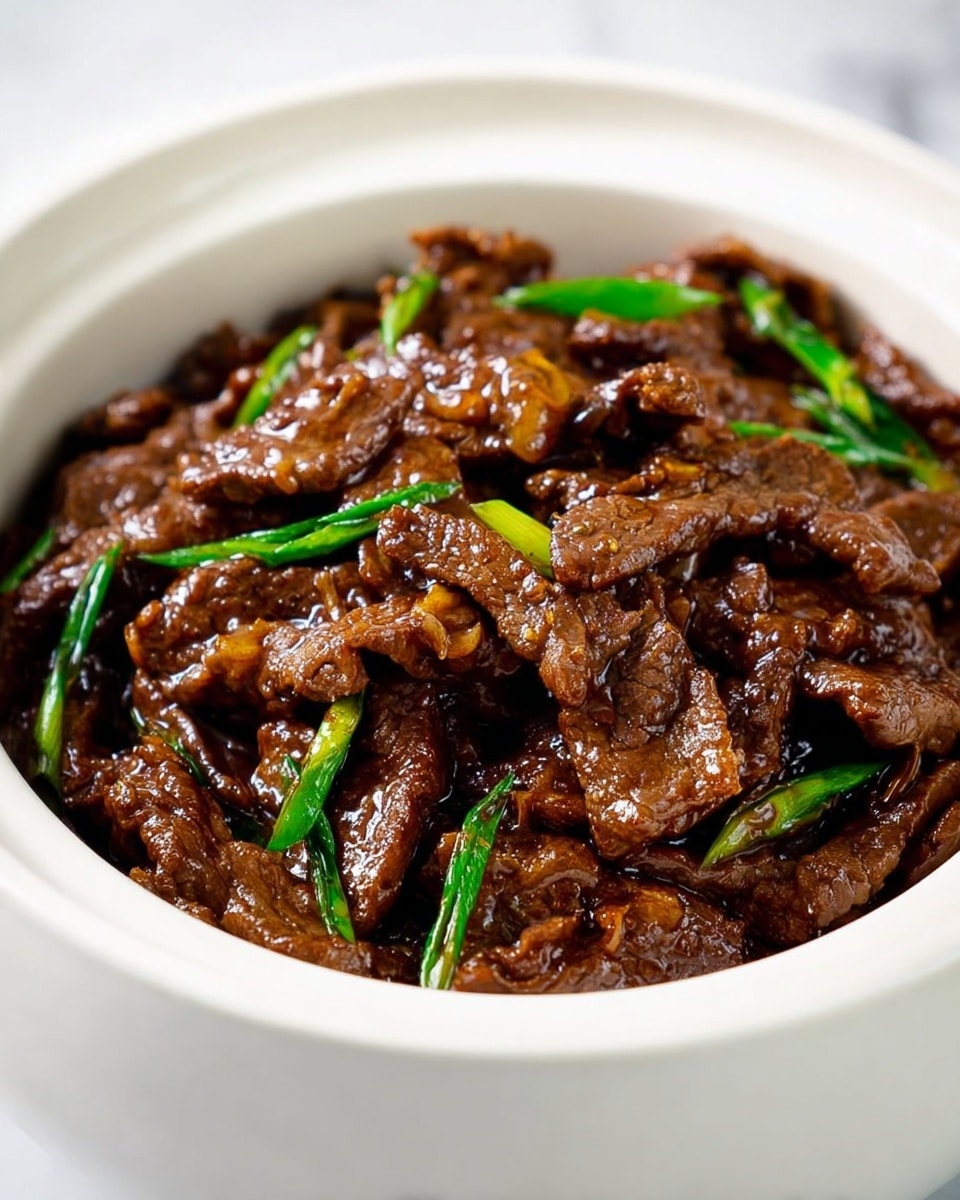 A bowl with a white marbled texture is filled with plain white rice as the bottom layer, topped with a generous portion of dark brown, glossy beef strips coated in a rich sauce as the middle layer, with green onion pieces scattered among the beef as the top layer. The beef looks tender with the sauce glistening under light. The bowl is placed on a white marbled surface, with blurred chopsticks visible in the background. photo taken with an iphone --ar 4:5 --v 7